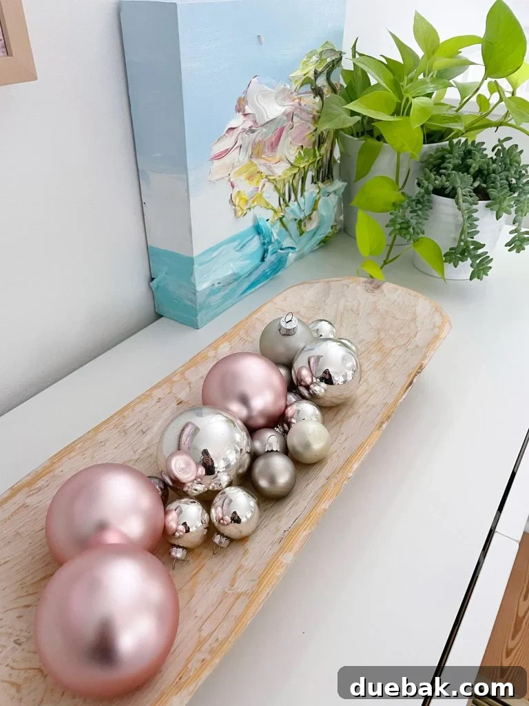 Joyful Simplicity: Our Holiday Edit 12 Detail of a minimalist tabletop ornament bowl on a media console, showcasing easy holiday decor