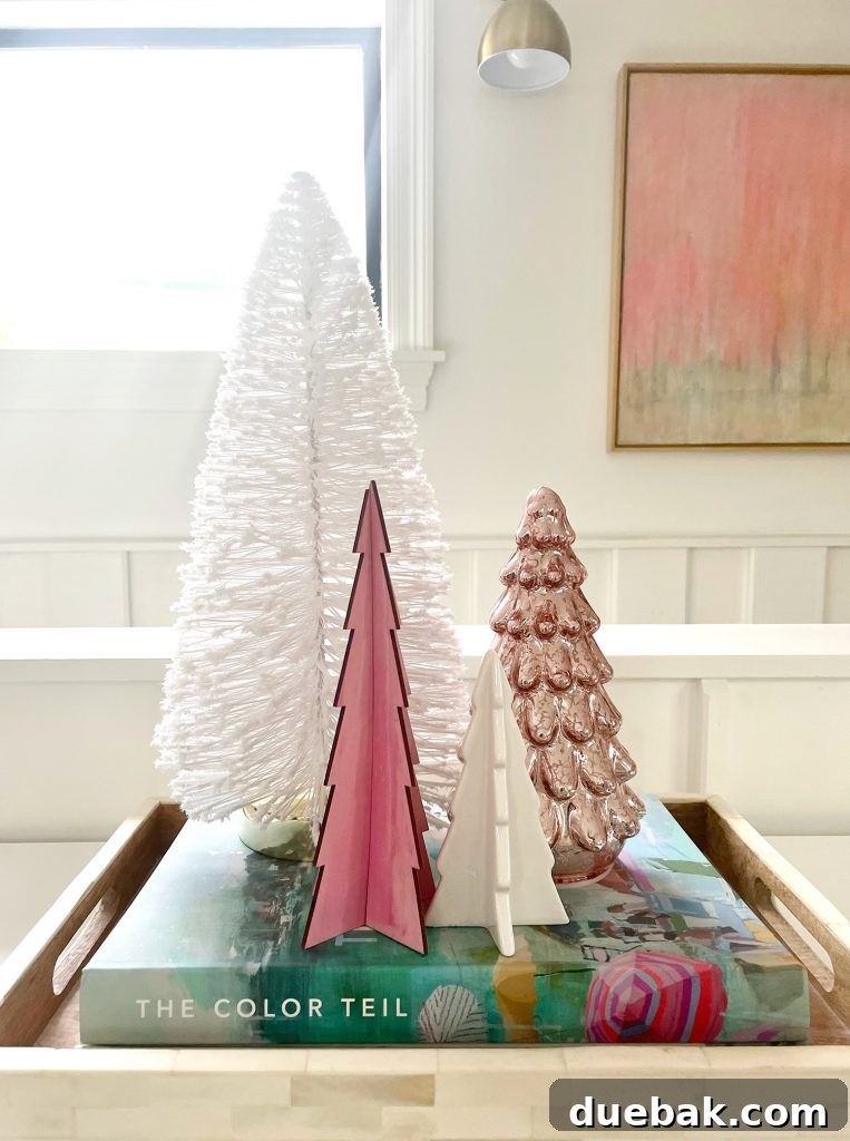 Joyful Simplicity: Our Holiday Edit 13 Assortment of charming decorative Christmas tabletop trees in pink and white, enhancing minimalist holiday decor