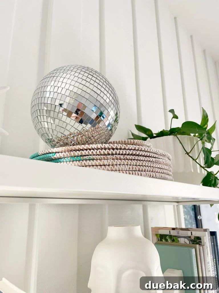 Joyful Simplicity: Our Holiday Edit 15 Decorative disco ball on top of office shelves, adding year-round festive sparkle to home decor