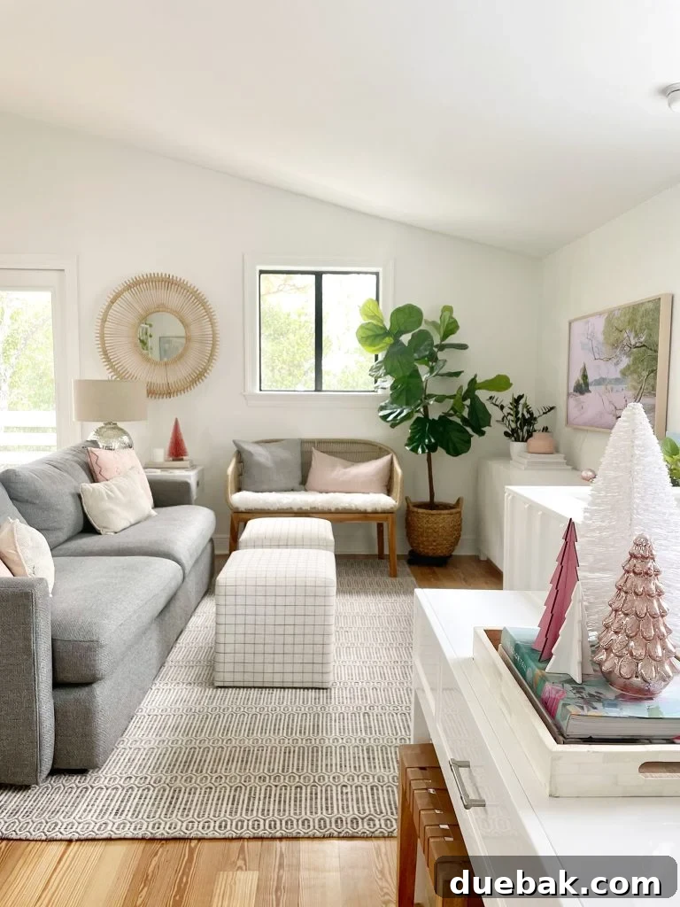 An expansive view of a living room showcasing a plush sheepskin loveseat and charming decorative Christmas trees adorning the tabletop, creating a warm, festive ambiance.