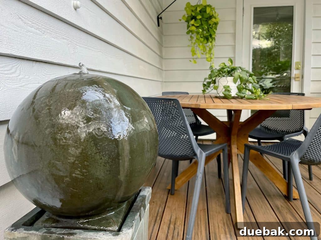 Close Up Of Outdoor Stone Ball Fountain, revealing its intricate details and soothing aesthetic.