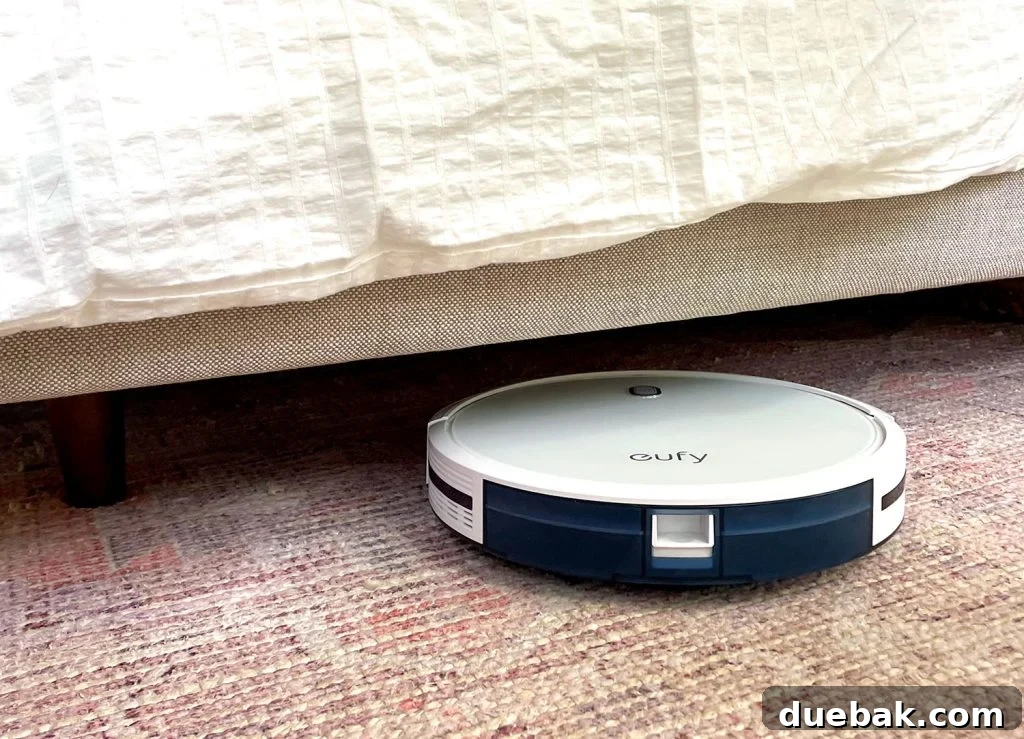 Eufy RoboVac 11S Max effectively cleaning under an upholstered bed frame
