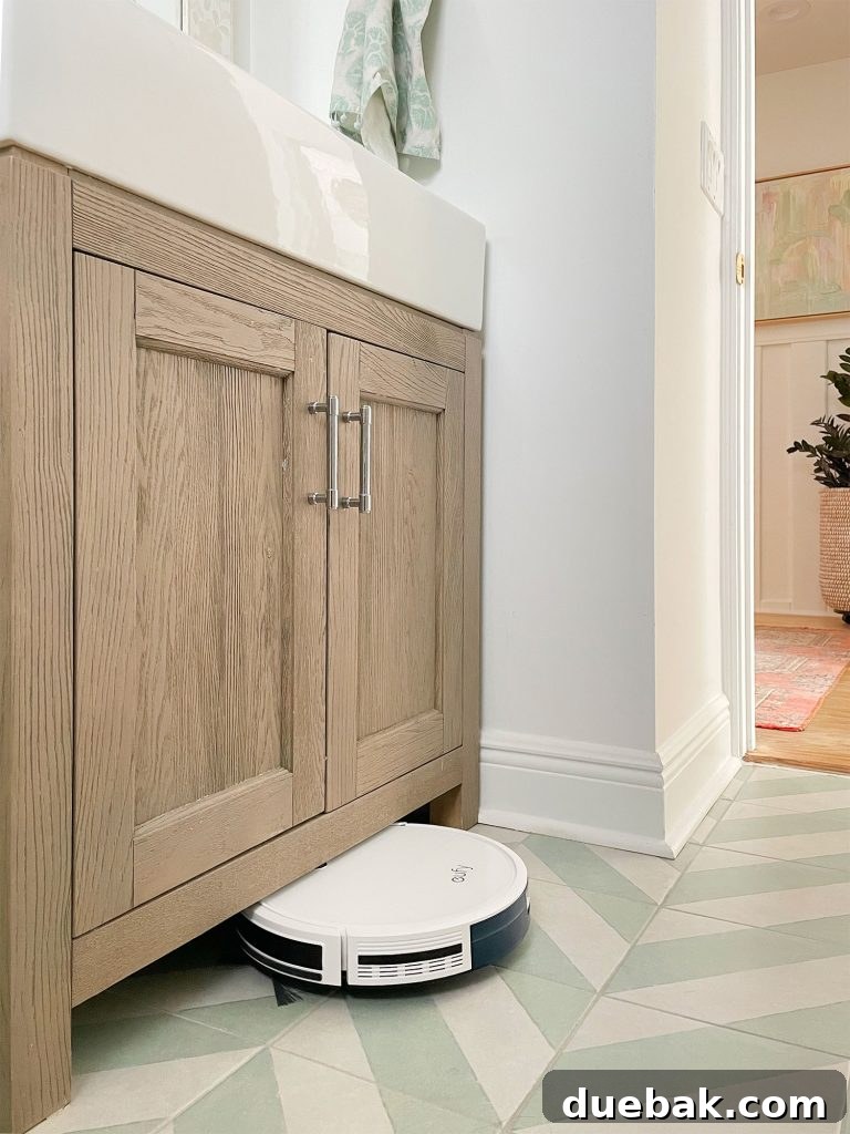The slim Eufy RoboVac 11S Max model effortlessly fitting under a low bathroom vanity