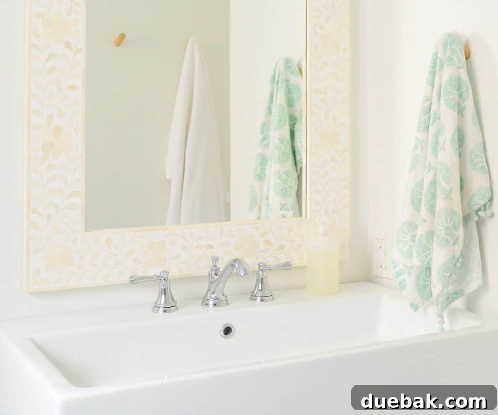 Bright modern bathroom with large white sink and bone inlay mirror