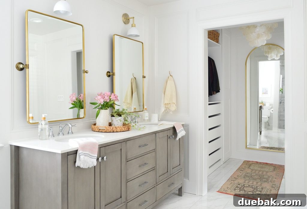 Large main bathroom after photo with gray vanity and walk in closet and arched mirror