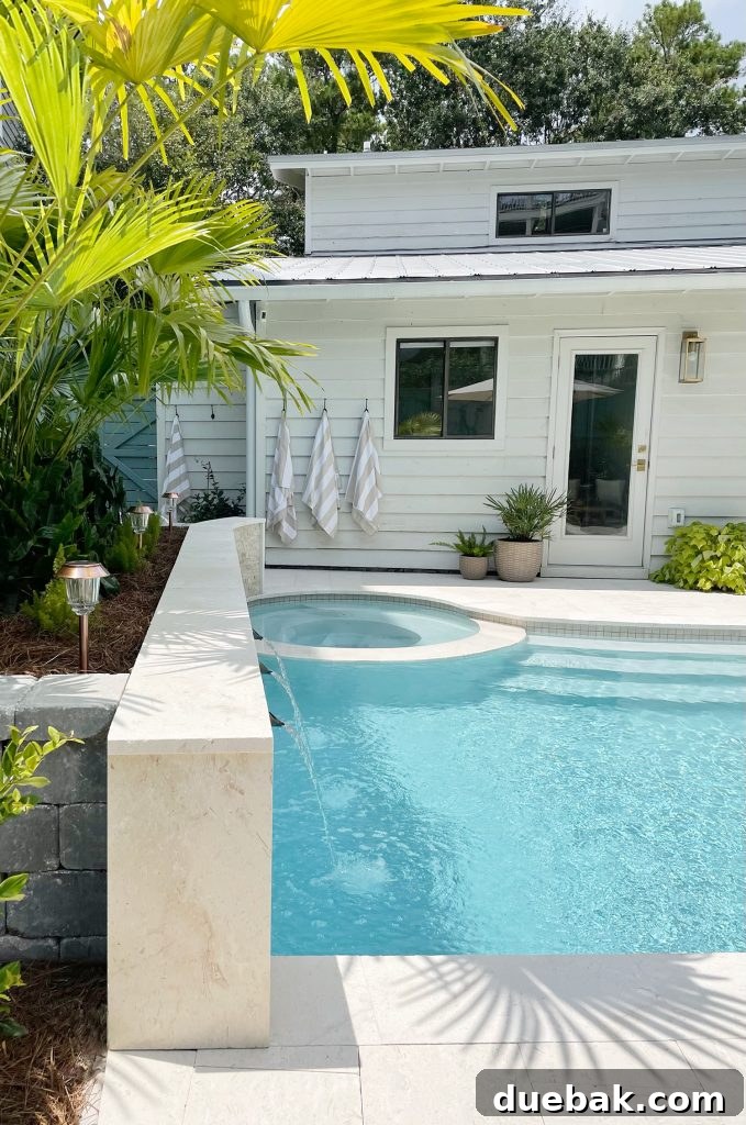 Backyard pool with round hot tub in small home backyard