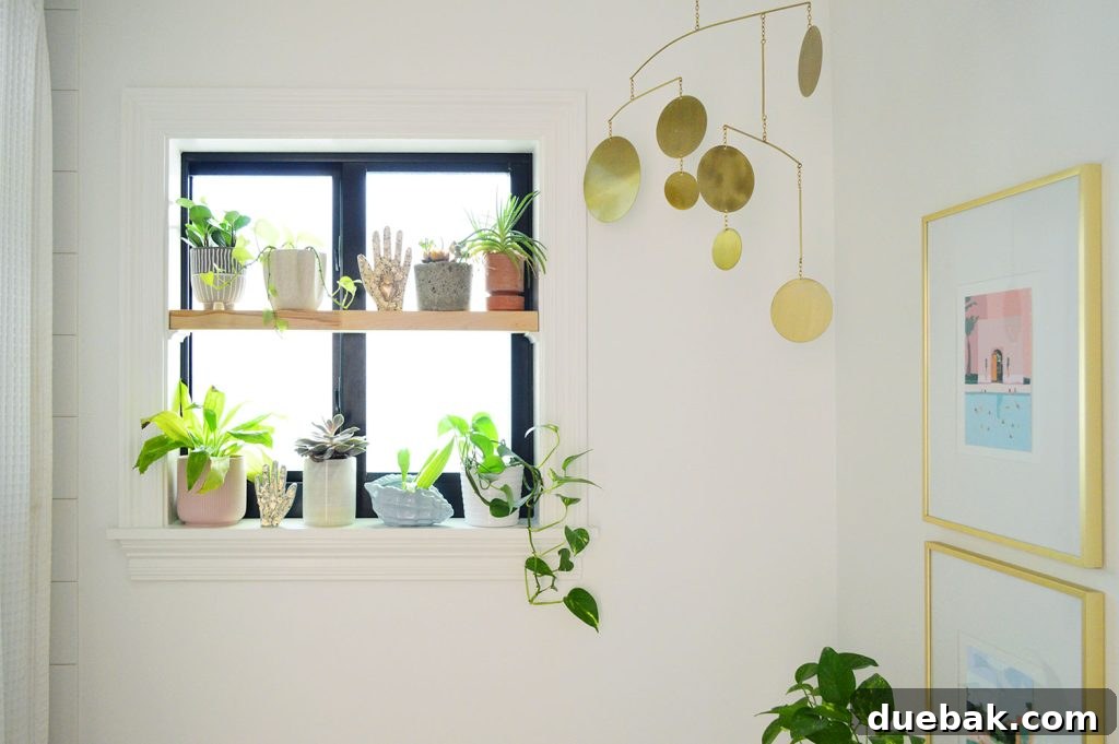 Wood window plant shelf in bathroom with gold mobile