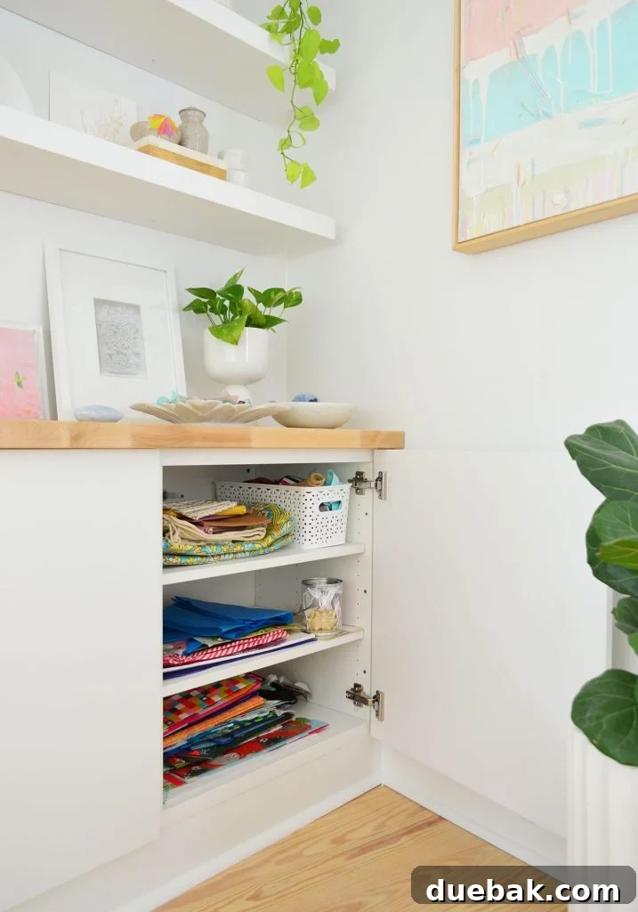 Open Besta Cabinet Under Floating Shelves With Gift Wrap Storage
