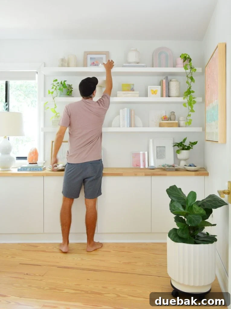John Reaching To Top Shelf Of Three Ikea Lack Floating Shelves