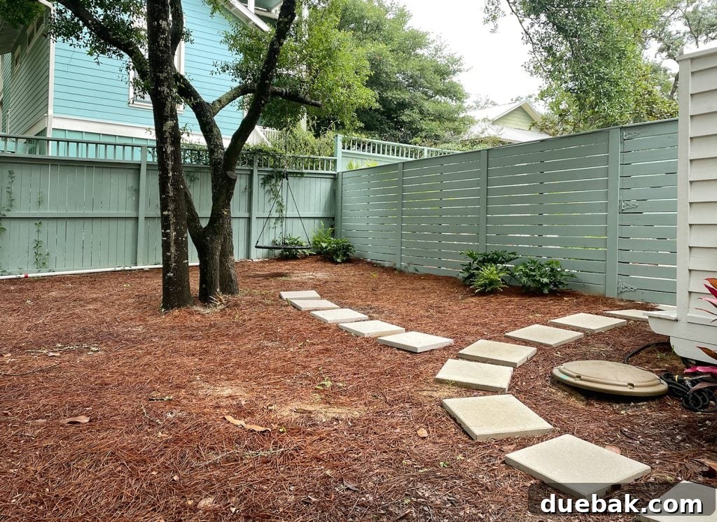 Concrete Pavers Leading To Fence And Swing