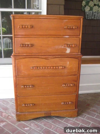 Dresser Revival: Paint and Contact Paper Drawer Makeover 2 Old, worn antique dresser before restoration, showing faded wood and original hardware.