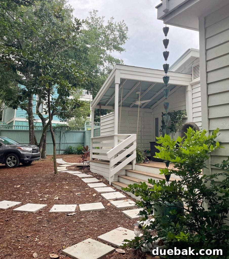Side view of home with small stone paver walkway in front of home