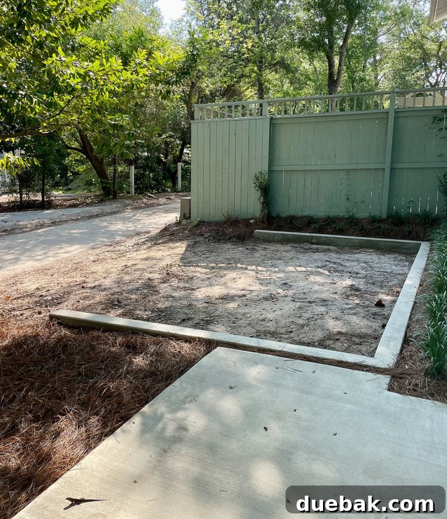 Concrete wall designating parking space by fence