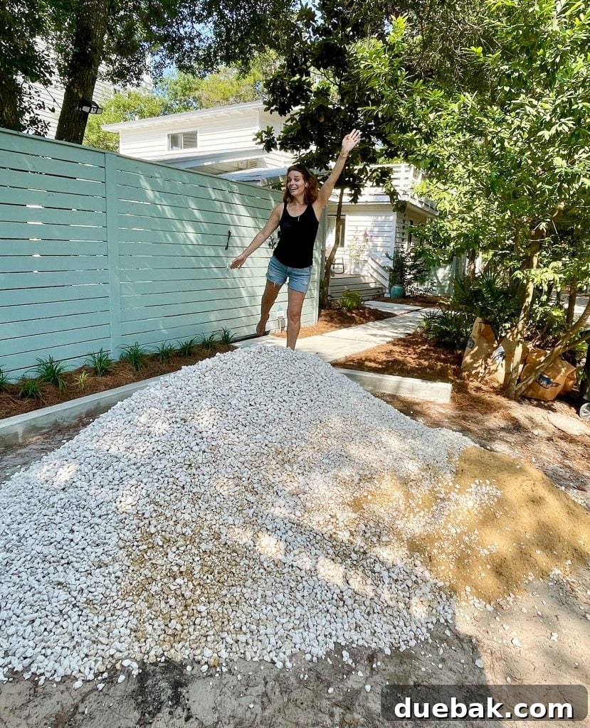 Sherry standing on top of freshly delivered pile of bahama rock gravel for driveway