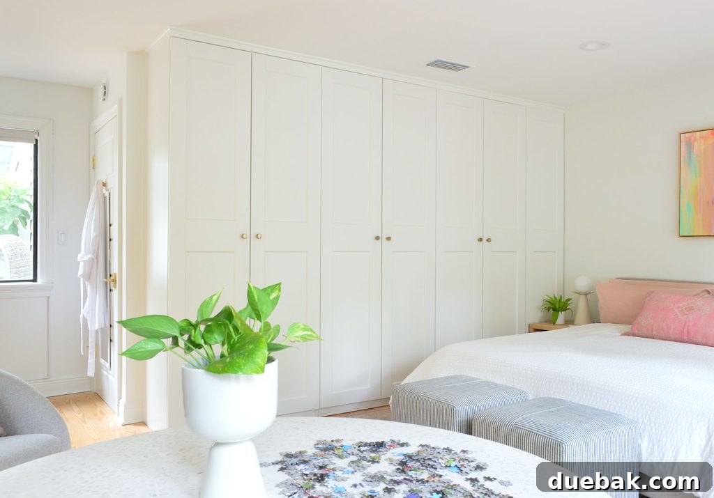 Row of Ikea Pax Wardrobes In Bedroom With Puzzle Table In Foreground