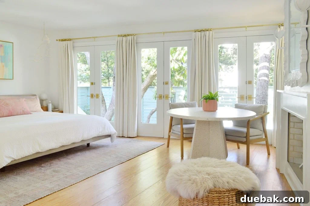 6 Clever Ways We Elevated Our Bedroom 2 Bright and airy beach-themed bedroom featuring a wall of French doors and elegant curtains