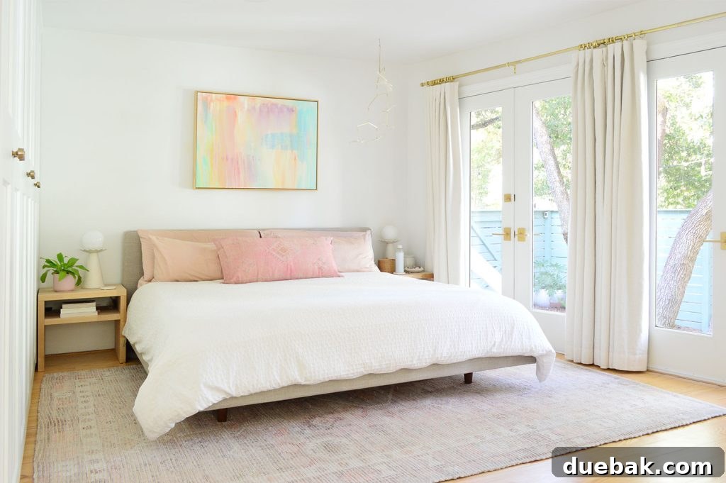 6 Clever Ways We Elevated Our Bedroom 13 Bright, beachy bedroom with a king-size bed, vibrant painting, and French doors overlooking a lush yard
