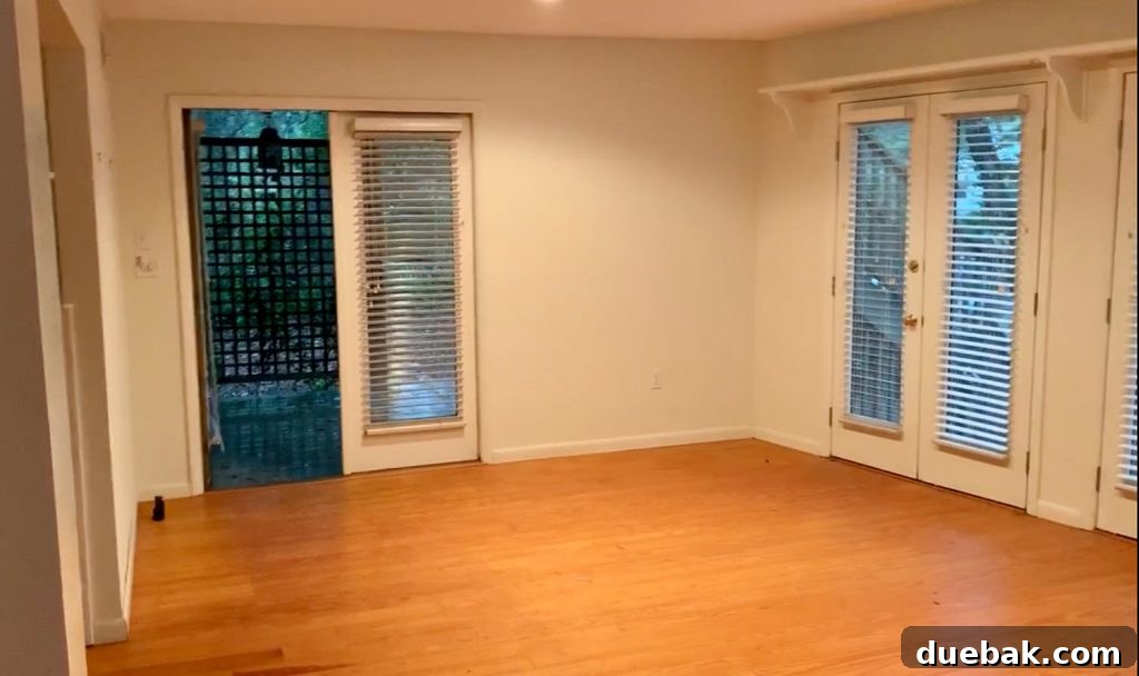 6 Clever Ways We Elevated Our Bedroom 15 Before photo of the living room, showing French doors on two walls, prior to its conversion into a bedroom