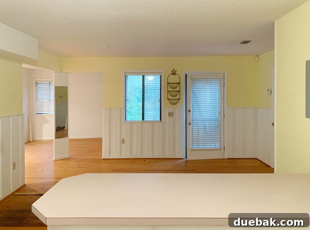 6 Clever Ways We Elevated Our Bedroom 28 Before photo of the kitchen with yellow walls looking into the adjacent bedroom area