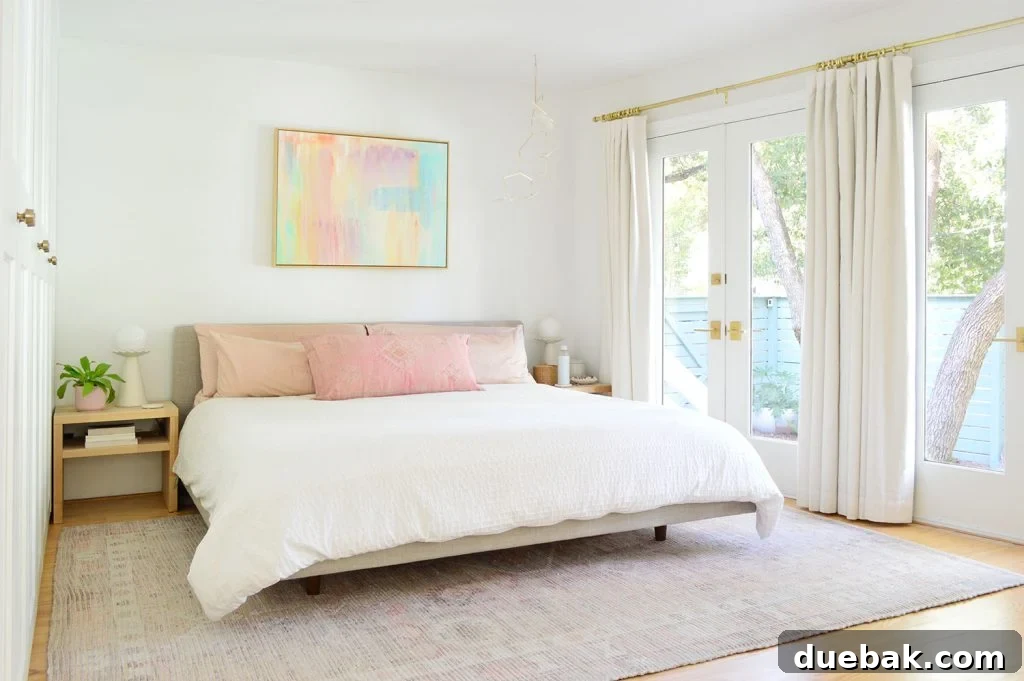6 Clever Ways We Elevated Our Bedroom 30 Bright, beachy bedroom showcasing a colorful painting, a comfortable king-size bed, and French doors that open to a serene yard