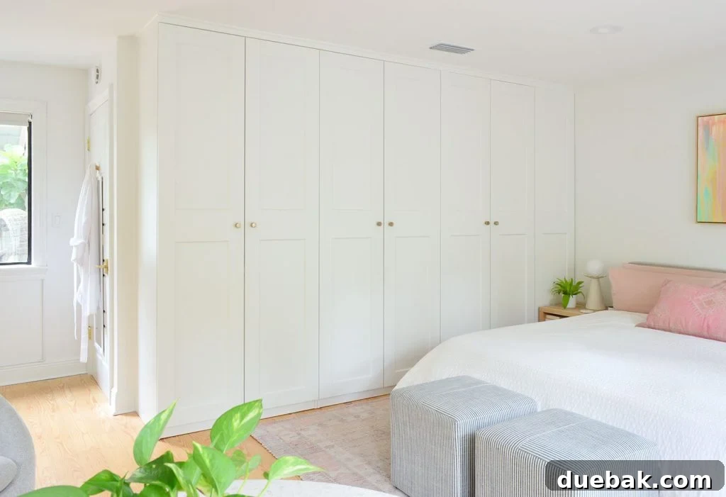 6 Clever Ways We Elevated Our Bedroom 6 A seamless row of Ikea Pax wardrobe closets in the bedroom, adorned with elegant gold knobs, providing ample storage.