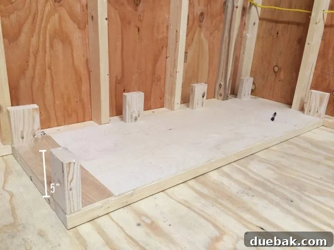 Adding small 5-inch posts to the bottom of the scrap wood storage organizer using pocket holes
