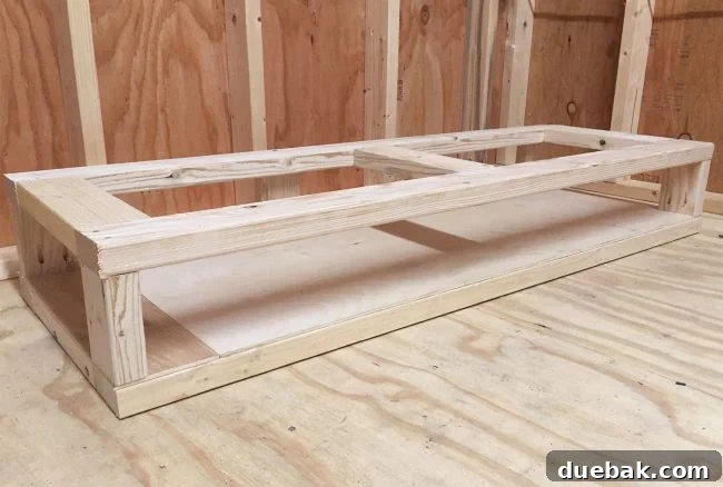 Adding a second level to the bottom of a simple scrap wood storage organizer for additional cubbies