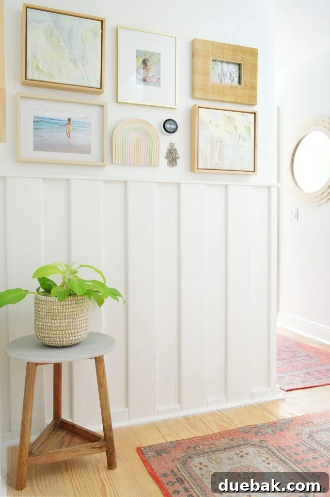 Sherwin Williams Pure White SW 7005 The Ultimate Whole House White 11 Wainscoting molding in a hallway painted Sherwin-Williams Pure White, demonstrating cohesive wall and trim color.
