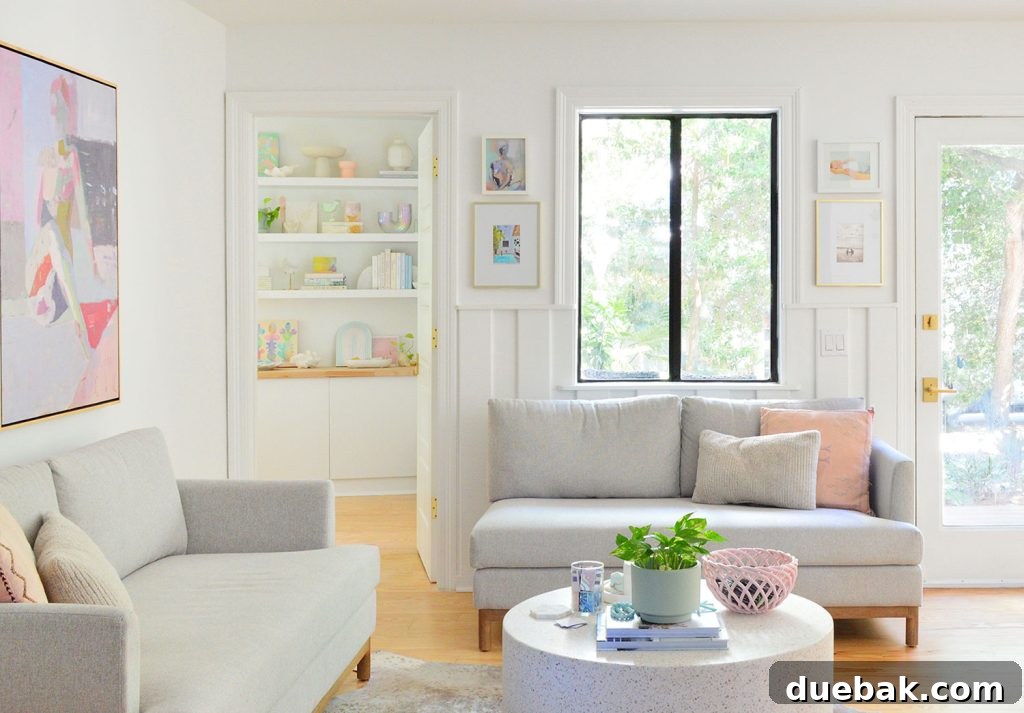 Sherwin Williams Pure White SW 7005 The Ultimate Whole House White 4 Close-up view of a sitting area with gray loveseats and Sherwin-Williams Pure White walls, showing its subtle warmth.
