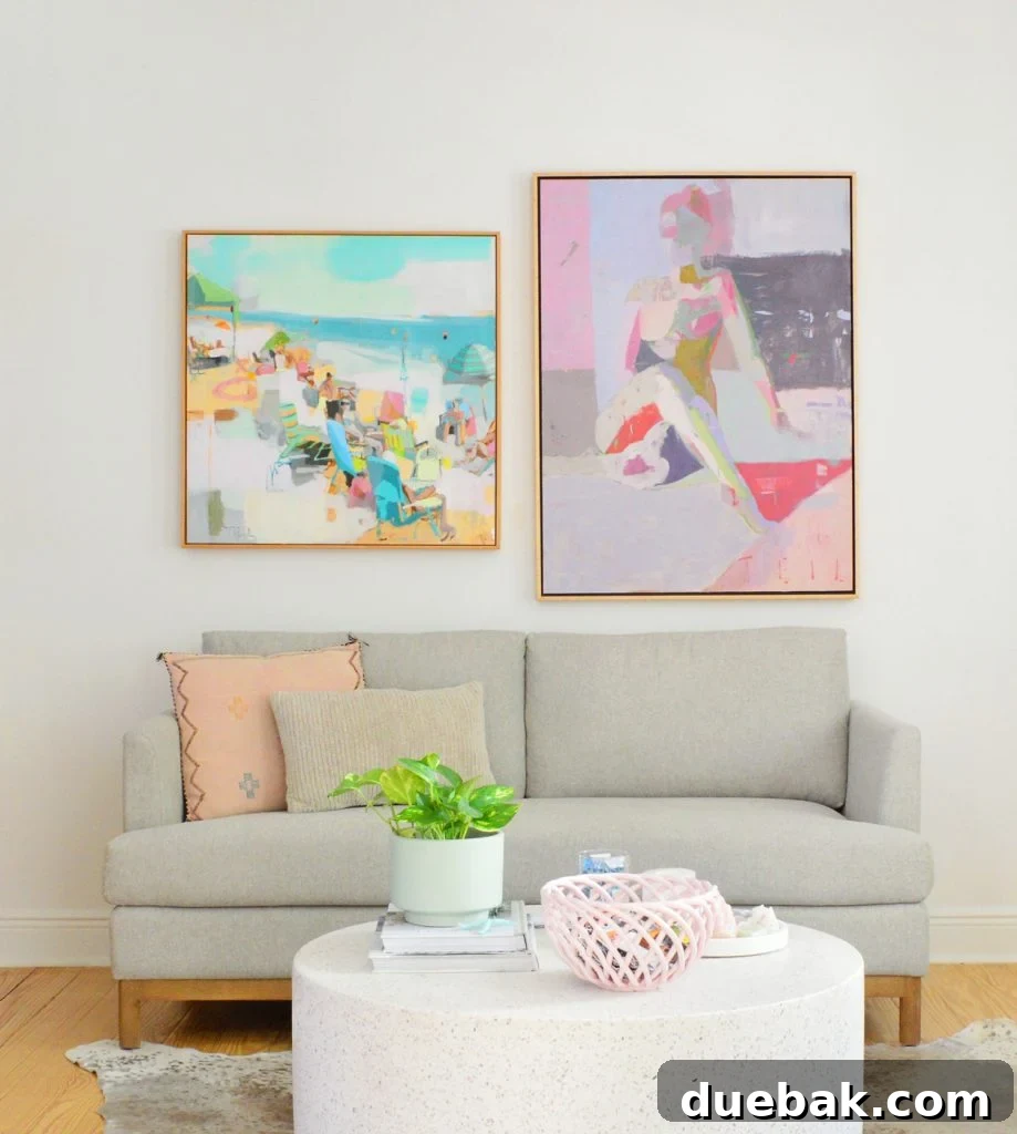 Sherwin Williams Pure White SW 7005 The Ultimate Whole House White 5 Loveseat against SW Pure White walls showcasing colorful paintings, highlighting the paint's neutral backdrop.