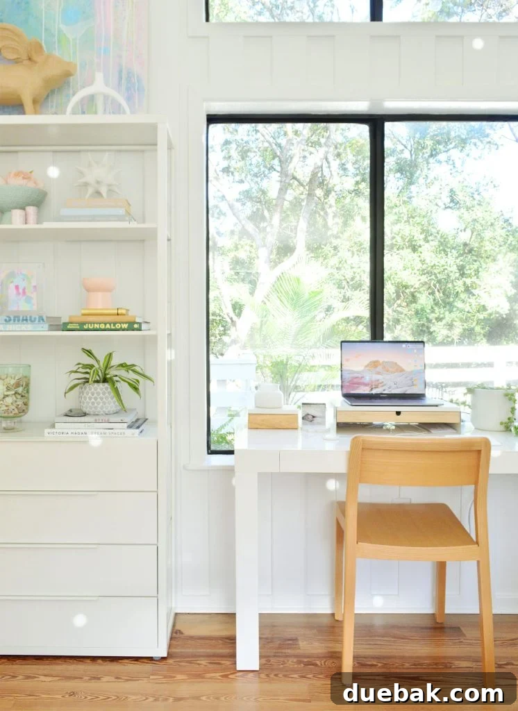 Sherwin Williams Pure White SW 7005 The Ultimate Whole House White 6 Home office with a large window and Sherwin-Williams Pure White walls, demonstrating its versatility with natural light.