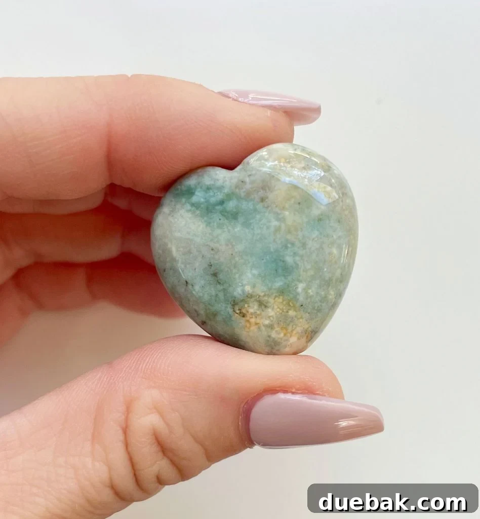 Ocean Jasper Crystal Heart Between Fingertips