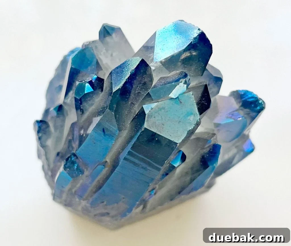 Close-up of a vibrant blue Angel Aura Quartz gemstone, showcasing its radiant iridescent surface.