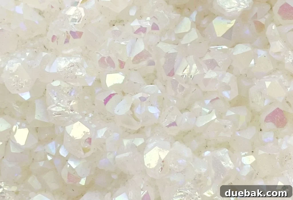 Extreme close-up of the intricate and shimmering iridescent pattern on an Aura Quartz gemstone.