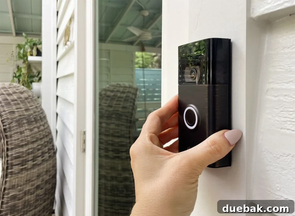 Ring Doorbell Setup Simplified in Five Steps 11 A hand placing the Ring Video Doorbell onto its securely mounted plate