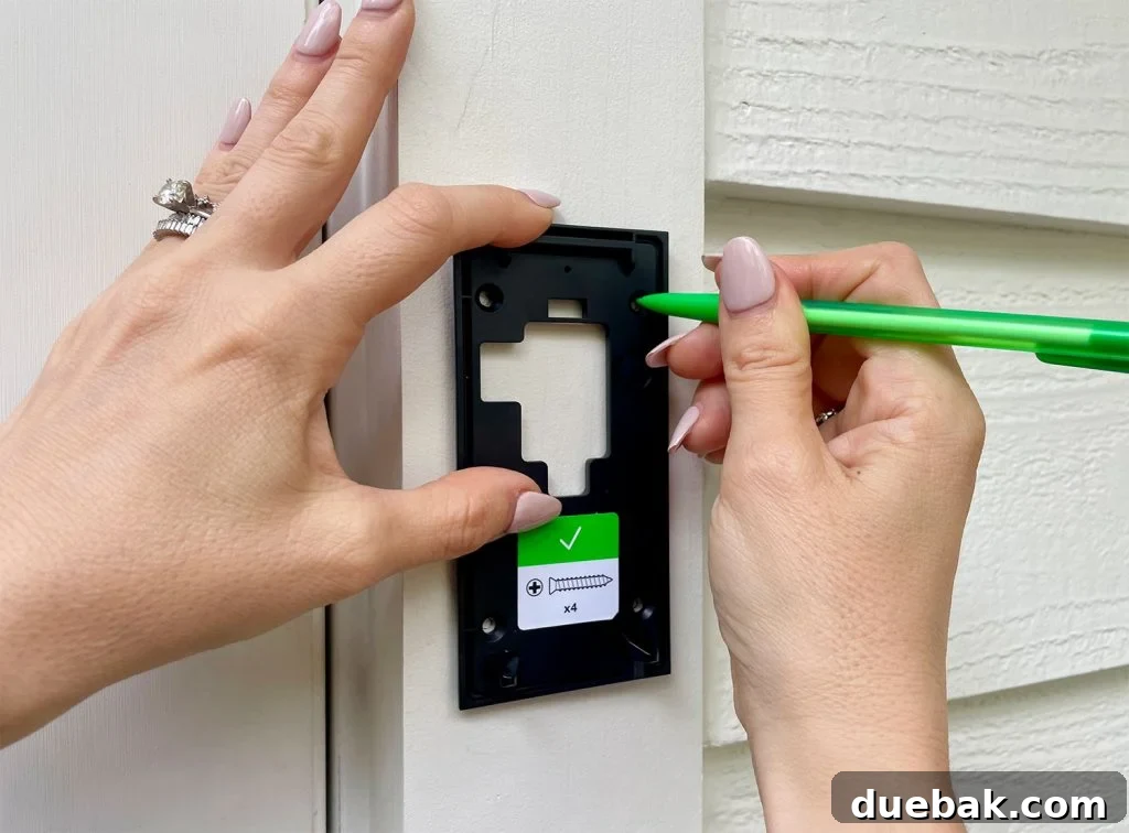Ring Doorbell Setup Simplified in Five Steps 8 Using a pencil to mark screw holes on the Ring Doorbell mounting plate for accurate installation