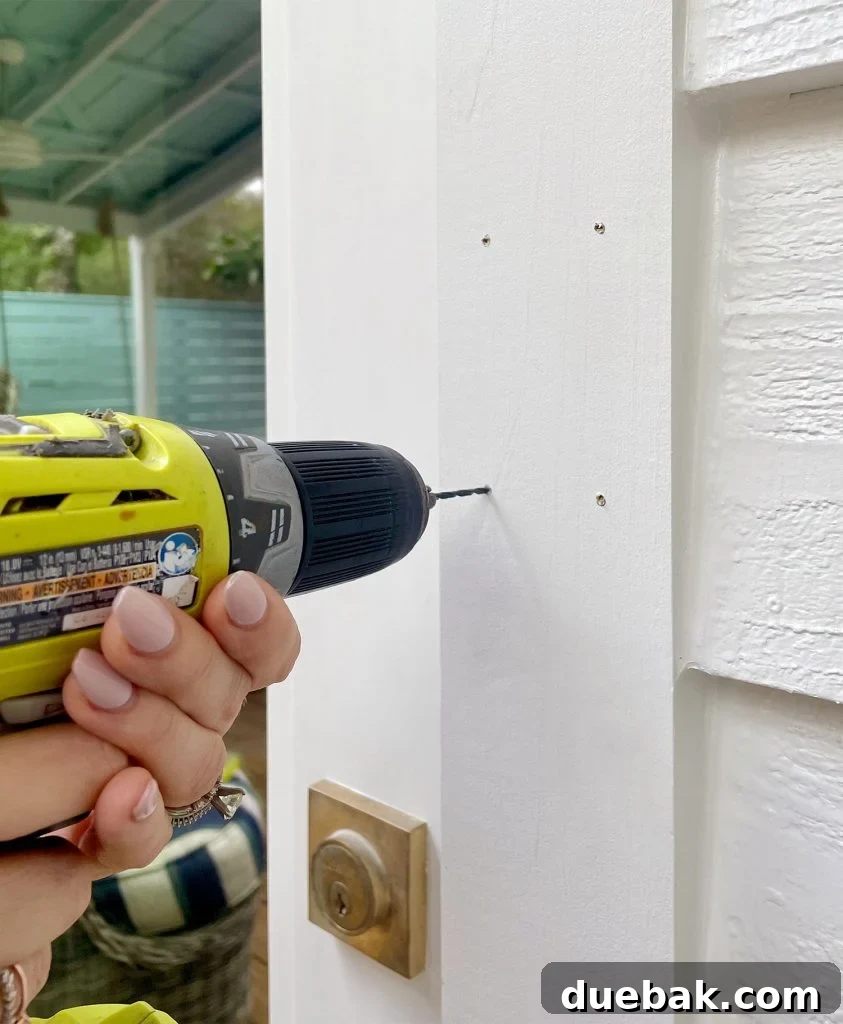 Ring Doorbell Setup Simplified in Five Steps 9 Drilling pilot holes for the Ring Video Doorbell mounting plate into a wooden door frame