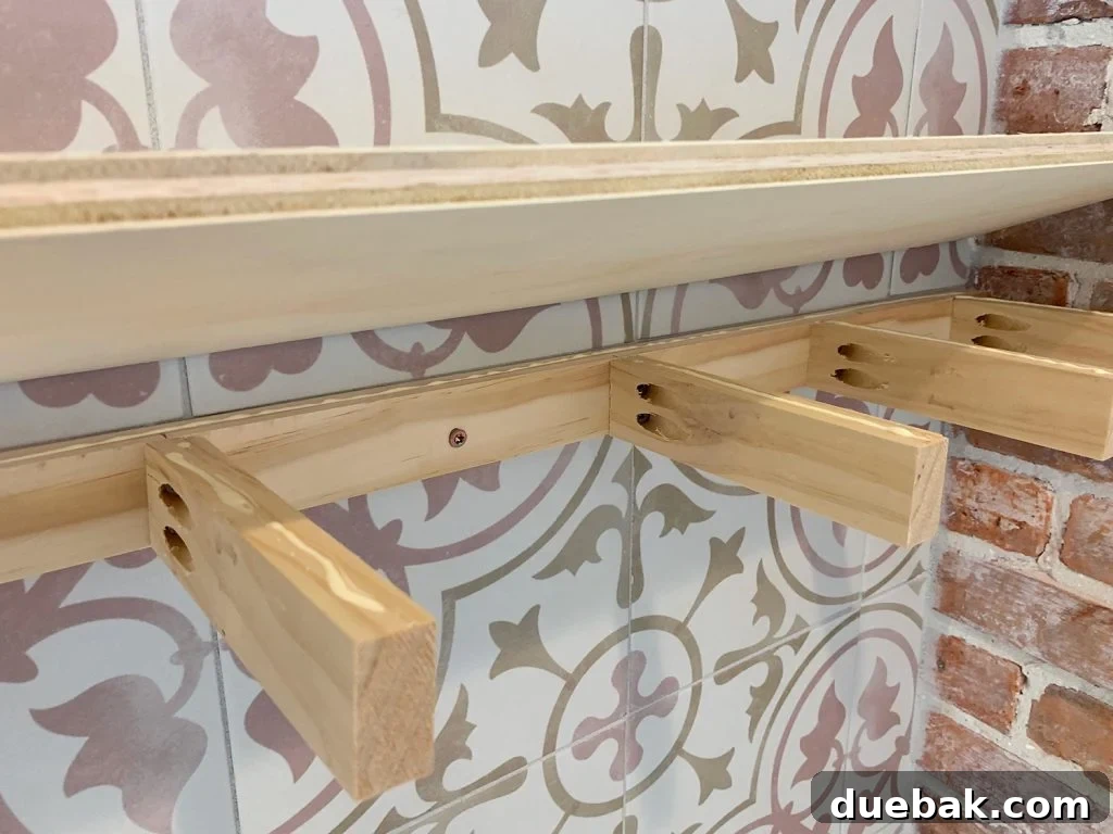 Elevate Your Kitchen with DIY Floating Shelves 12 Plywood Top Being Lowered Onto a Wooden Support Bracket for DIY Floating Shelves, demonstrating assembly