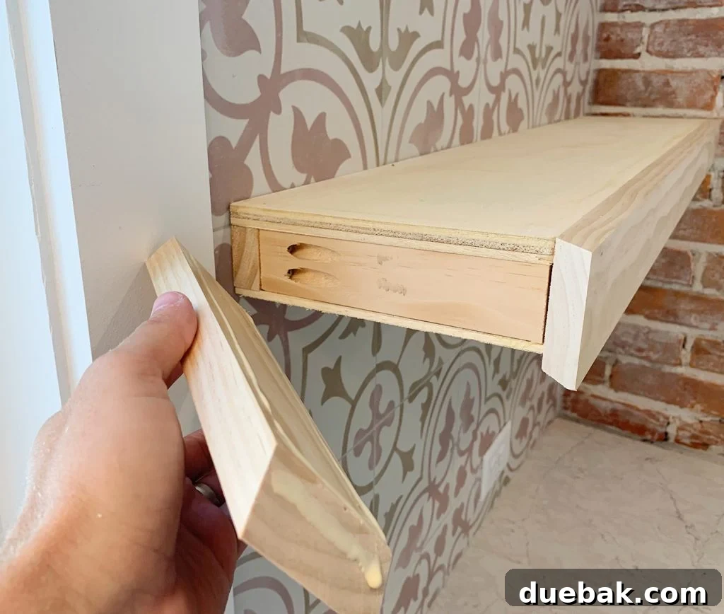Elevate Your Kitchen with DIY Floating Shelves 14 Hand Adding a Side Trim Piece to DIY Floating Kitchen Shelves, showing the finishing process