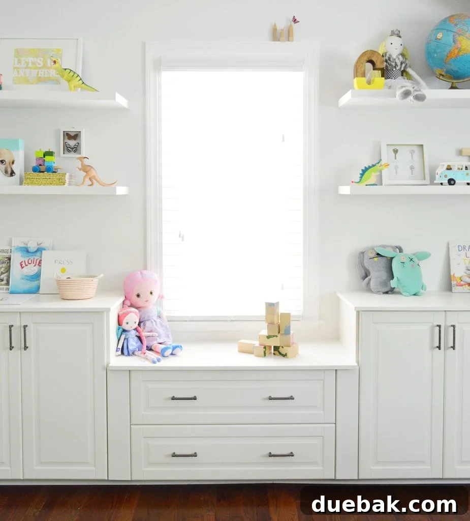 Crafting Custom Built-In Cabinetry 11 Completed built-in cabinets with elegant pulls under a window, featuring integrated floating shelves in a beautifully decorated playroom