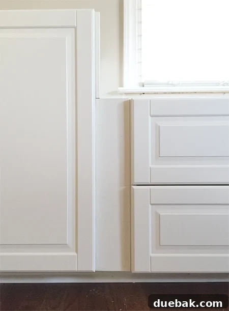 Crafting Custom Built-In Cabinetry 8 Close-up detail of a filler piece between two white Ikea Sektion cabinets with Bodbyn doors, showing the recessed gap between the door and the filler before the second layer is applied