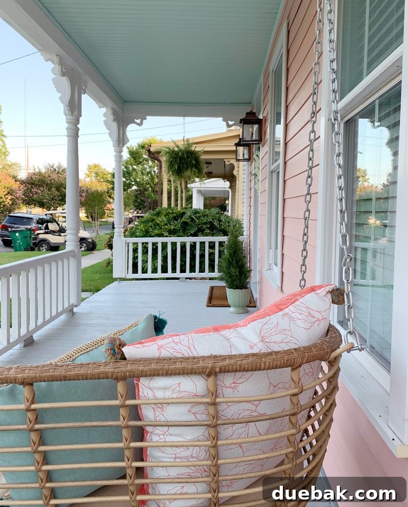 Southern Serenity: Top Haint Blue Paint Shades 4 Haint Blue ceiling on a traditional Southern porch with white trim.