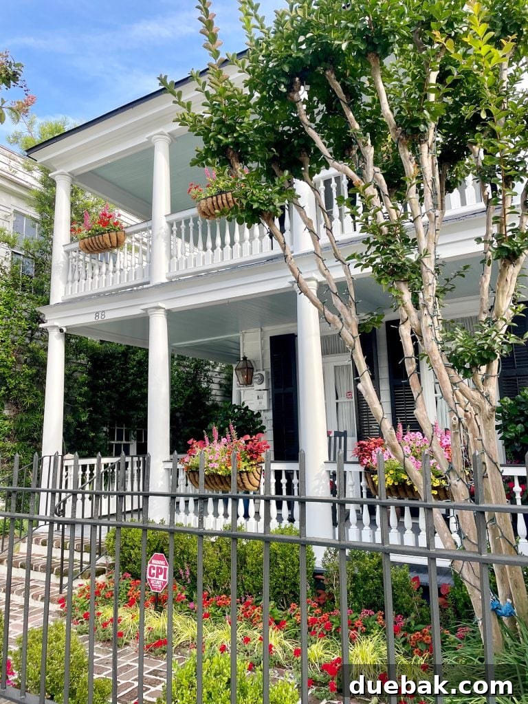 Southern Serenity: Top Haint Blue Paint Shades 5 Historic Home With Window Boxes In Charleston South Carolina, showcasing a beautiful Haint Blue porch ceiling.