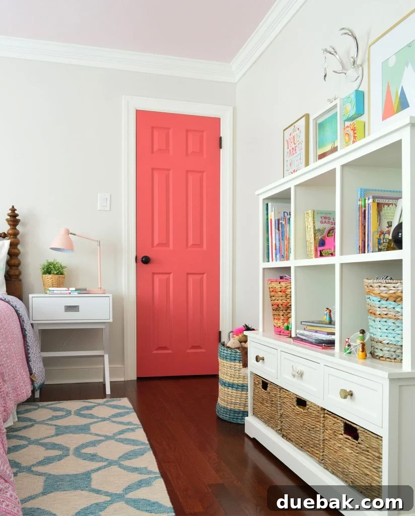 Girls Bedroom With Greige Walls And Simply White Trim And Pink Door - A vibrant and personal space.