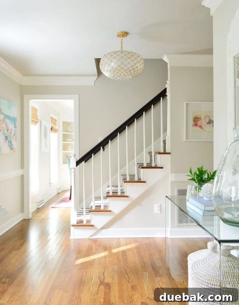 Bright Foyer With Edgecomb Gray Paint On Walls and Revere Pewter On Ceiling - An example of complementary greige pairing.