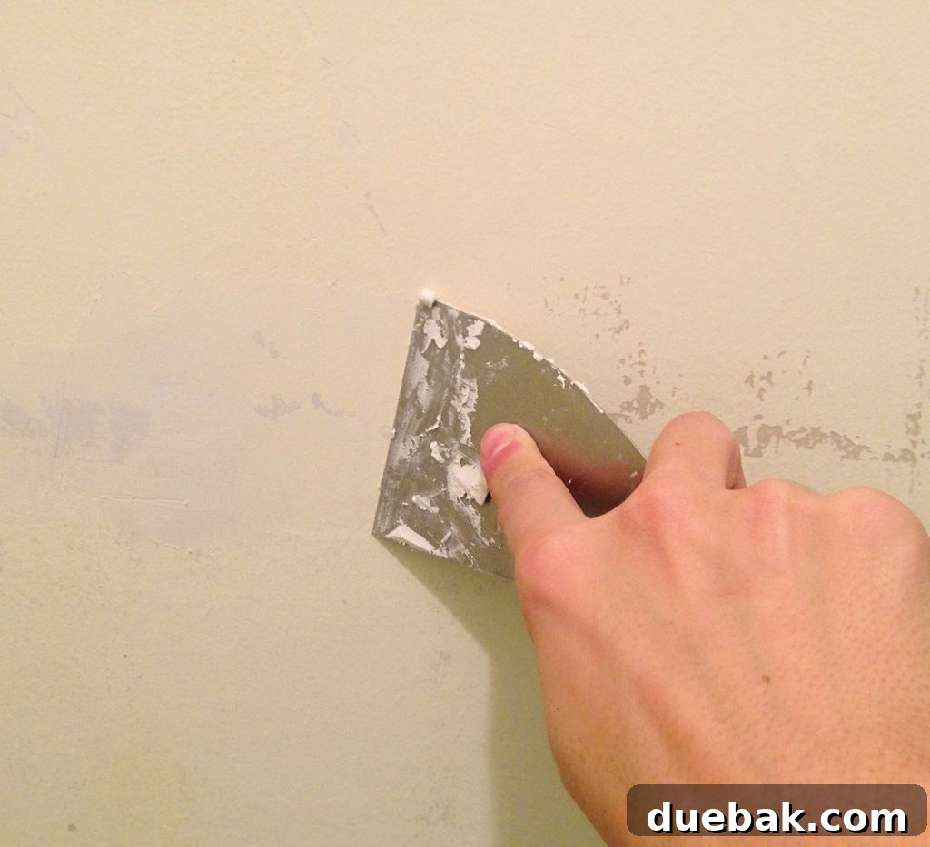 Spackling Peeled Paint Patches With A Putty Knife