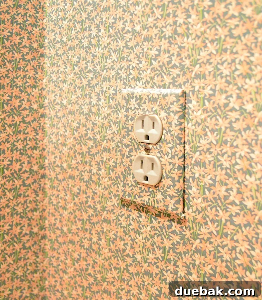Wall outlet cover with floral wallpaper