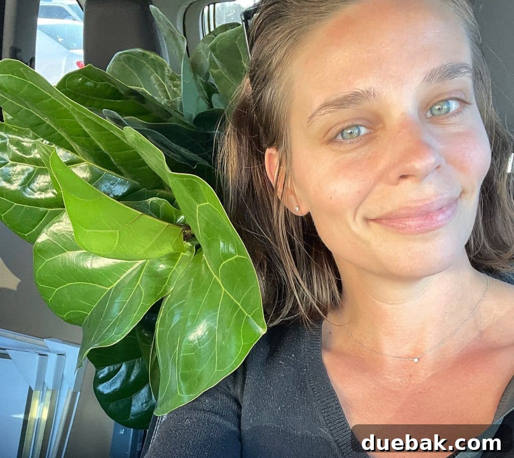 Sherry sitting with fiddle leaf fig in car