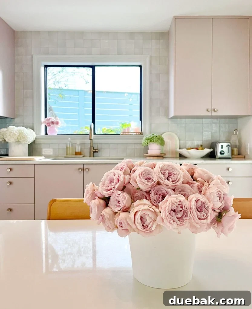 Our Cozy Kitchen-Living Nook 2 Pink Roses On Breakfast Table In Kitchen With Mauve Cabinets And Tile Backsplash