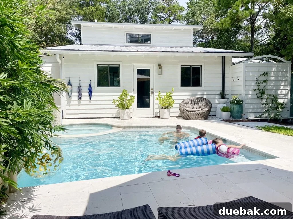 John and kids joyfully swimming in a backyard pool, embodying outdoor living